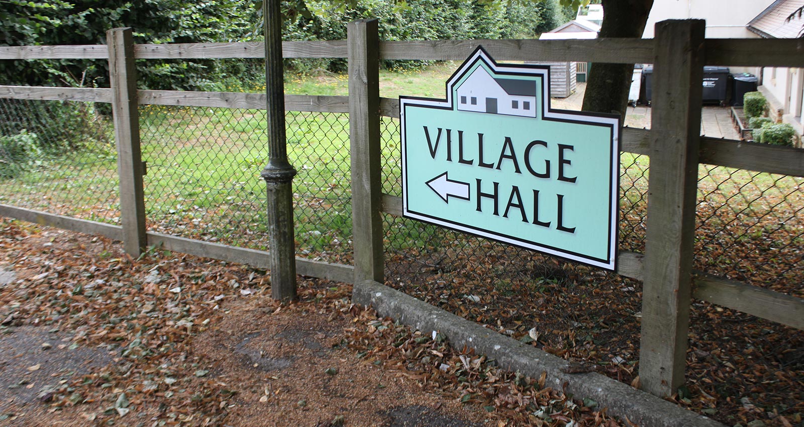 Village hall sign with arrow